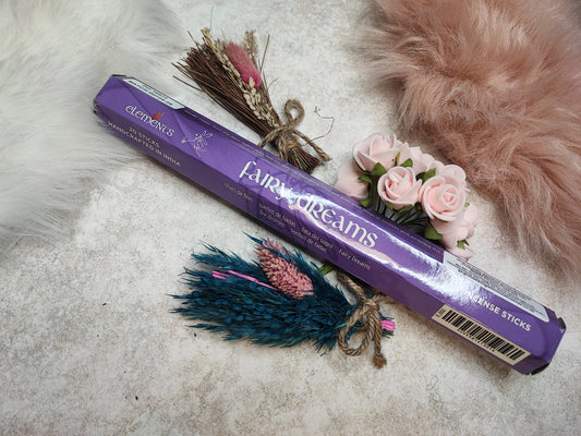 Duftholz Räucherstäbchen Fairy Dreams von Mein Shop, aromatischer Rauch, natürliche Verpackung, umgeben von Blumen und Kräutern.